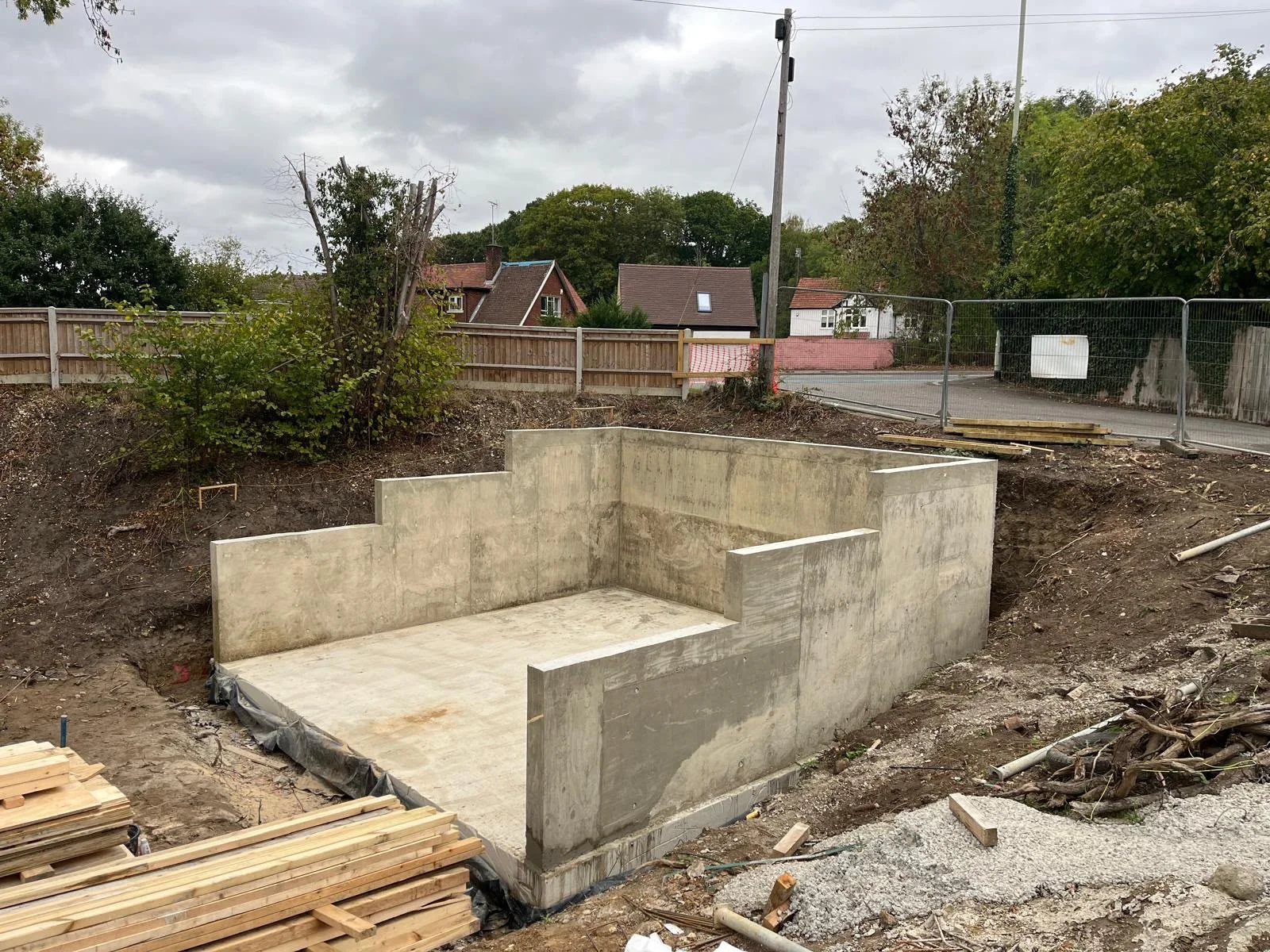 Finished reinforced concrete basement slab and stepped walls, angled view